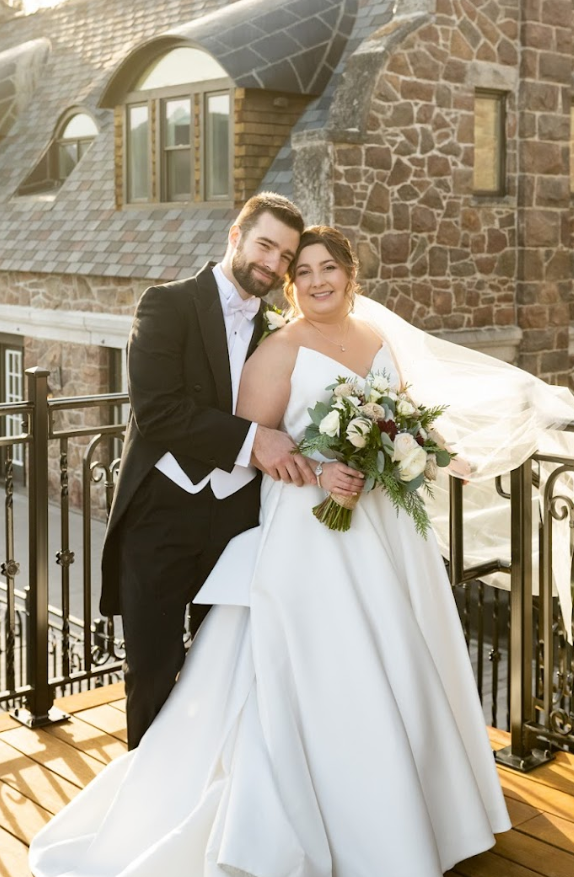 Bride and groom on rooftop in strapless dress